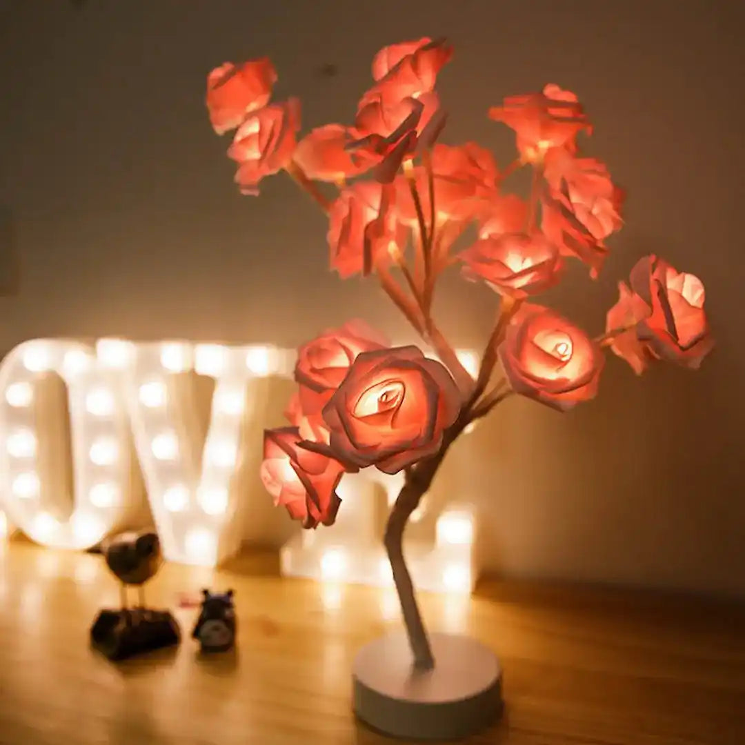 Decorative LED flower lamp on a wooden surface with 'LOVE'
