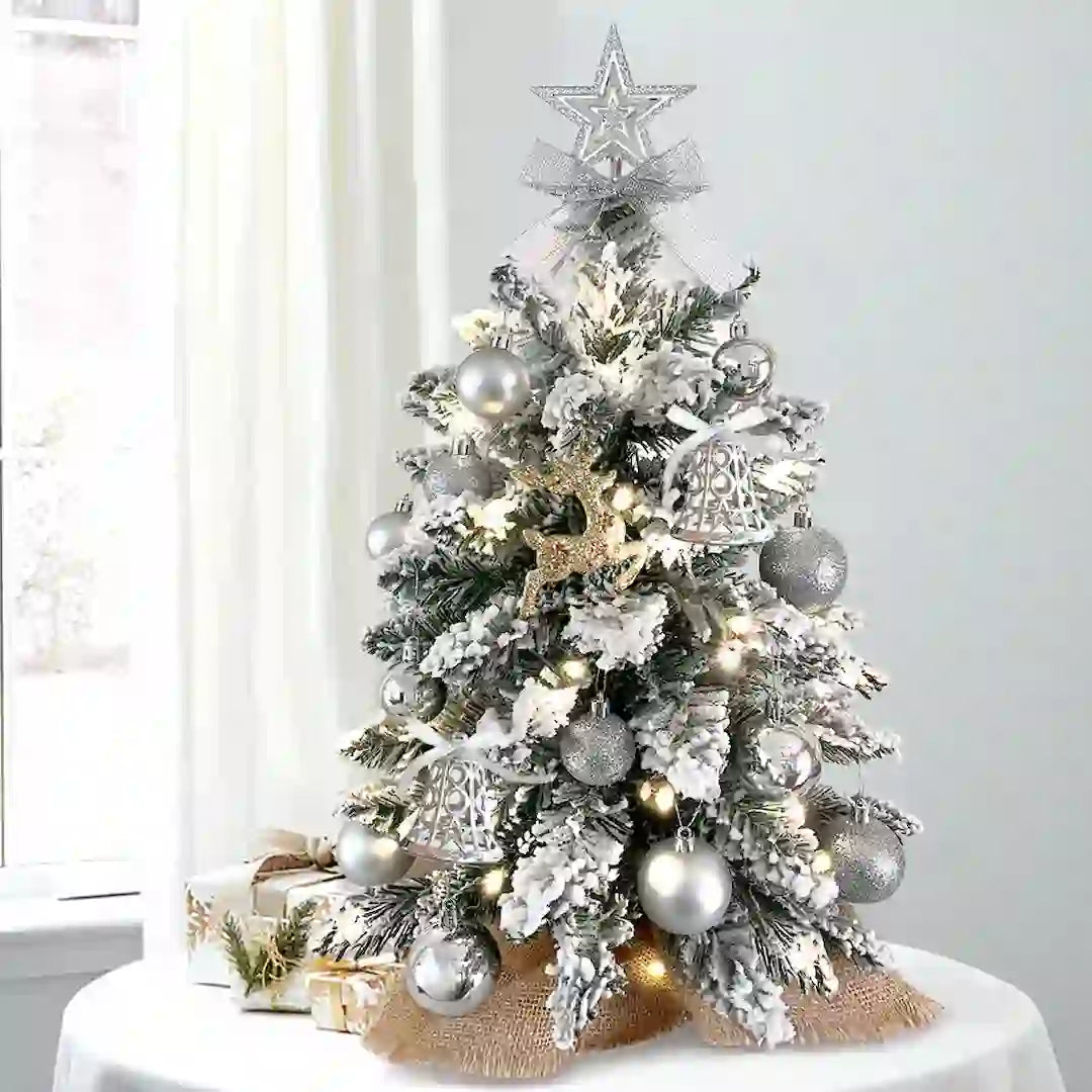 Close-up of silver ornaments and flocked snow on mini tree