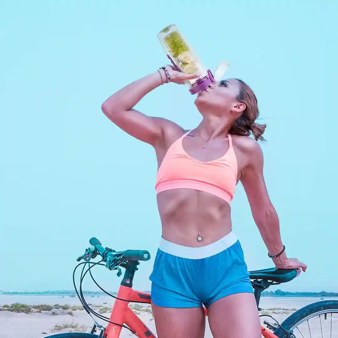Fruit Infuser Water Bottle filled with fruits and water on a gym bench