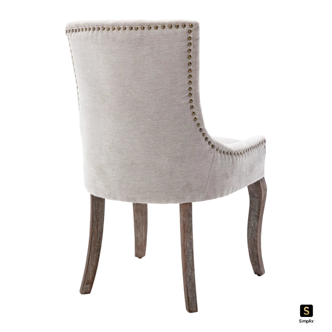 Beige dining chair with bronze nail head trim