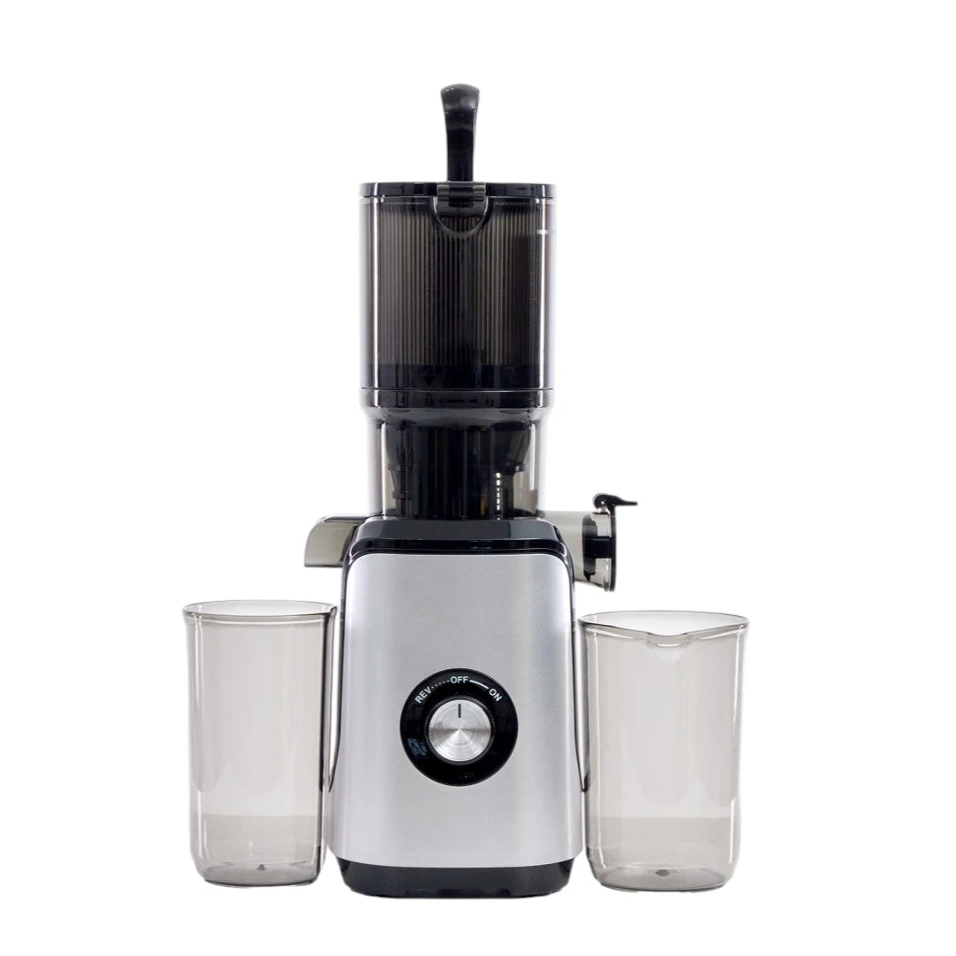 Juicer with 4.25-inch wide feeding chute showing whole apple and carrot being inserted.