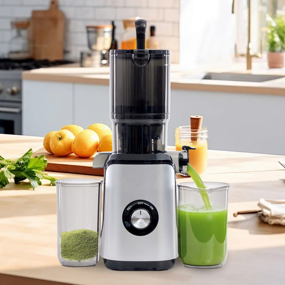 Modern cold juicer preparing fresh juice from fruits and vegetables in a clean kitchen environment.
